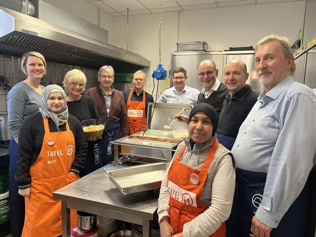 An der Schöpfkelle und den Tafelgästen das Mittagessen serviert haben in diesem Jahr (v.l.): Fachbereichsleiterin Leonie Braun, Tafelmitarbeiterin Iman Maaraui, Hauptamtsleiterin Birgit Francavilla, die Fachbereichsleiter Bernd Walz und Thomas Mügge, Bürgermeister Marcus Röwer, Oberbürgermeister Bernd Häusler, Personalchef Dietmar Streit und Fachbereichsleiter Torsten Kalb, vorne Dalal Kashkoush gemeinsam mit Eva Pal (nicht auf dem Foto), Leiterin der Tafelküche. | Foto: Stadt Singen